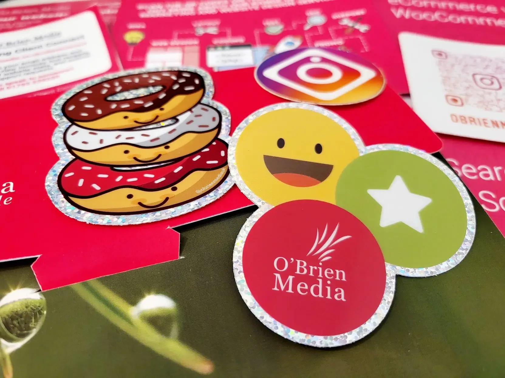 O’Brien Media stickers and printed brochures on a desk